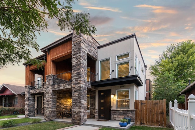 3941 Vallejo St, Denver, CO 80211 - modern home featuring a balcony, stone siding, and fence