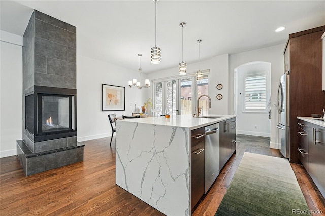 3941 Vallejo St, Denver, CO 80211 - kitchen with a sink, stainless steel appliances, baseboards, a center island with sink, and modern cabinets