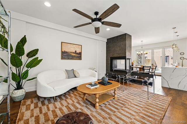 3941 Vallejo St, Denver, CO 80211 - living room featuring hardwood / wood-style flooring, ceiling fan, recessed lighting, a chandelier, and a tile fireplace