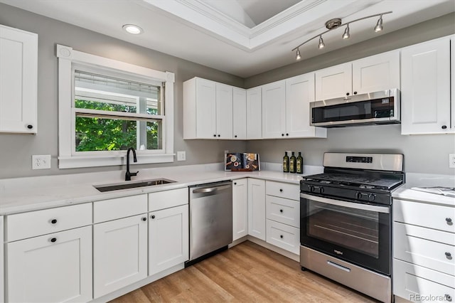 1895 S Emerson St, Denver, CO 80210 - kitchen featuring appliances with stainless steel finishes, light countertops, light wood finished floors, white cabinets, and recessed lighting