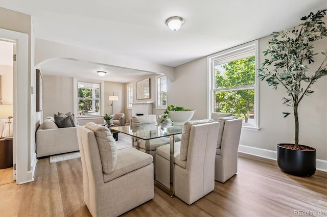 1895 S Emerson St, Denver, CO 80210 - dining space with arched walkways and light wood-style flooring