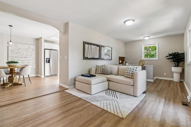 1895 S Emerson St, Denver, CO 80210 - living room featuring light wood-style flooring and arched walkways