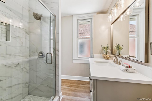 1895 S Emerson St, Denver, CO 80210 - bathroom with a stall shower, wood finished floors, plenty of natural light, and vanity
