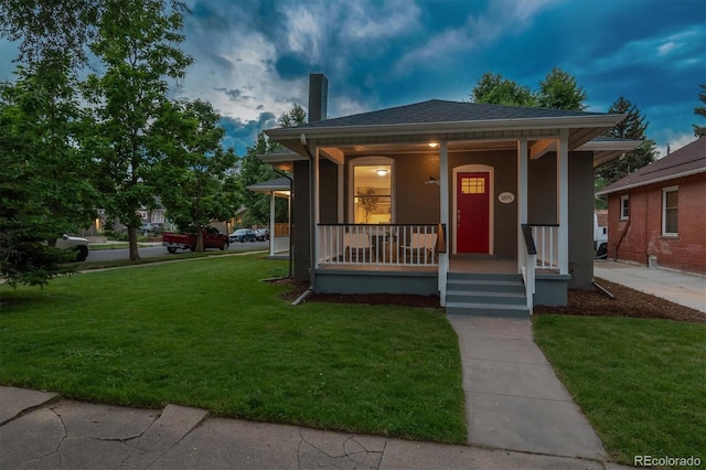 1895 S Emerson St, Denver, CO 80210 - bungalow-style house with a porch, a chimney, and a front lawn