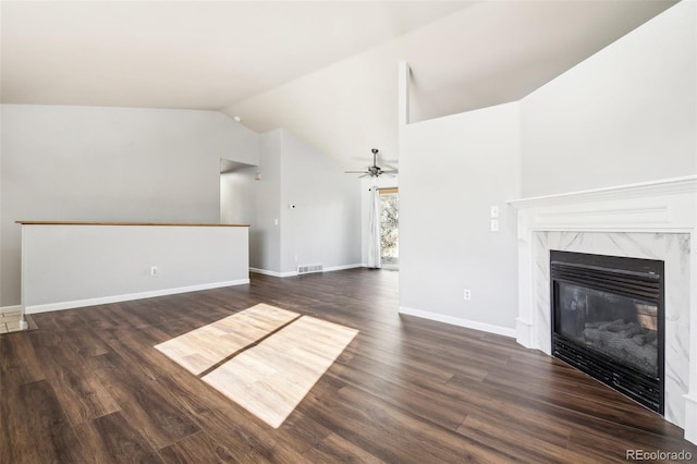 unfurnished living room with ceiling fan, dark hardwood / wood-style flooring, lofted ceiling, and a high end fireplace