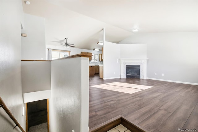 unfurnished living room with ceiling fan, wood-type flooring, and lofted ceiling