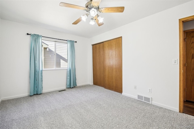 unfurnished bedroom featuring carpet flooring, ceiling fan, and a closet