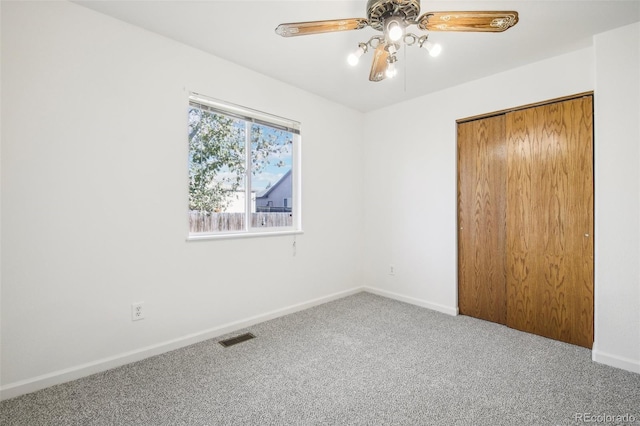 unfurnished bedroom featuring carpet flooring, ceiling fan, and a closet