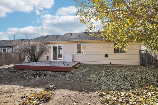 rear view of house featuring a deck