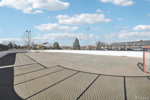 view of home's community featuring tennis court