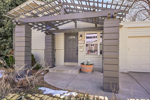 7240 S Cherry Dr, Centennial, CO 80122 - doorway to property with a garage, brick siding, and a pergola