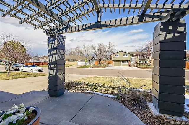 view of patio / terrace with a residential view and a pergola