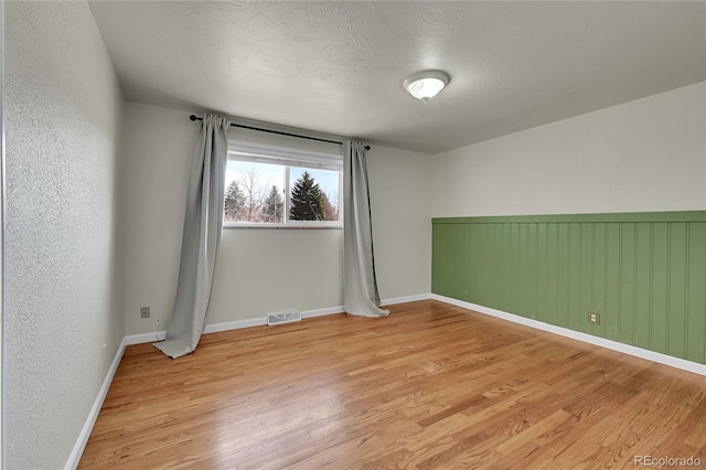 7240 S Cherry Dr, Centennial, CO 80122 - spare room with light wood-type flooring, baseboards, and visible vents