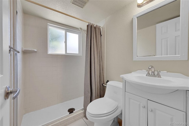 7240 S Cherry Dr, Centennial, CO 80122 - full bath featuring a textured wall, toilet, visible vents, vanity, and a stall shower