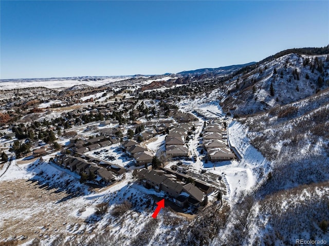 snowy aerial view featuring a mountain view