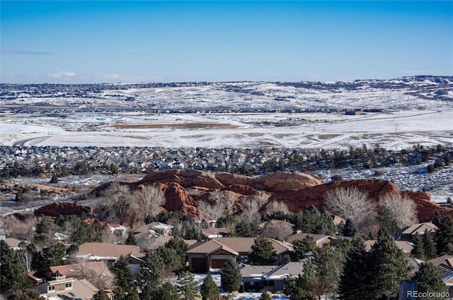 snowy aerial view with a mountain view