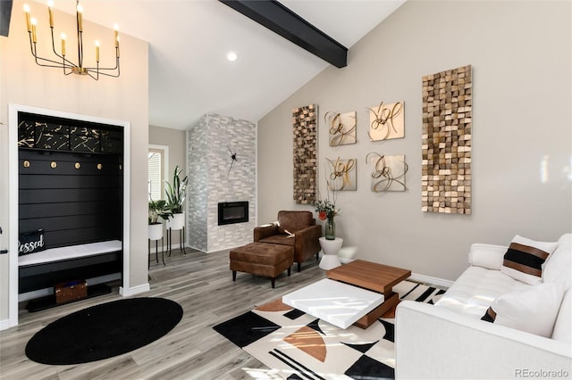 living room with high vaulted ceiling, a large fireplace, a chandelier, hardwood / wood-style flooring, and beam ceiling