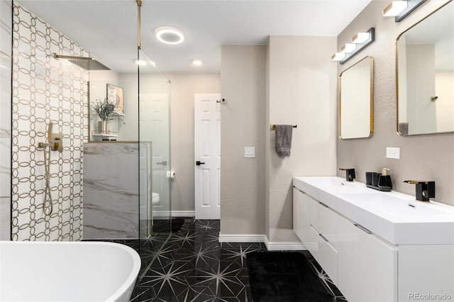 6980 Fargo Trl, Littleton, CO 80125 - bathroom featuring a soaking tub, double vanity, a walk in shower, and baseboards