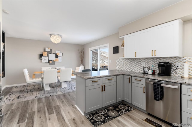 6980 Fargo Trl, Littleton, CO 80125 - kitchen with dishwasher, light wood finished floors, a peninsula, open shelves, and tasteful backsplash
