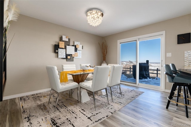 6980 Fargo Trl, Littleton, CO 80125 - dining room with a chandelier, wood finished floors, and baseboards