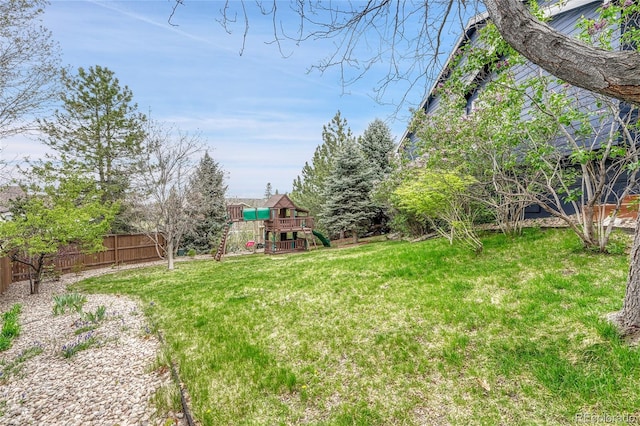 view of yard with a playground and fence