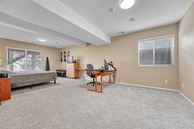 carpeted bedroom featuring baseboards and visible vents