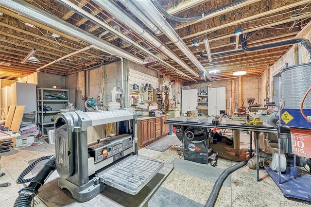 unfinished basement featuring a workshop area
