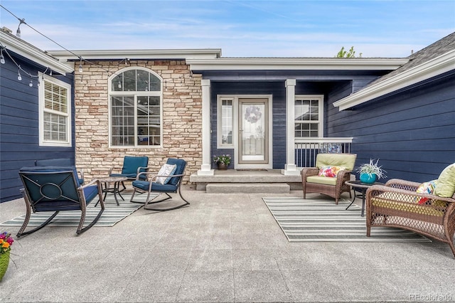 property entrance featuring covered porch and stone siding