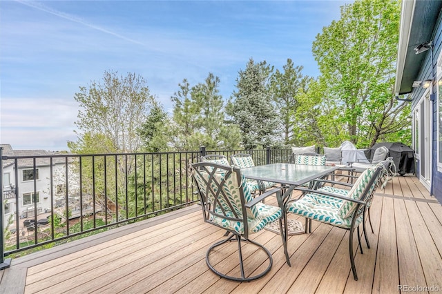 wooden terrace with outdoor dining area