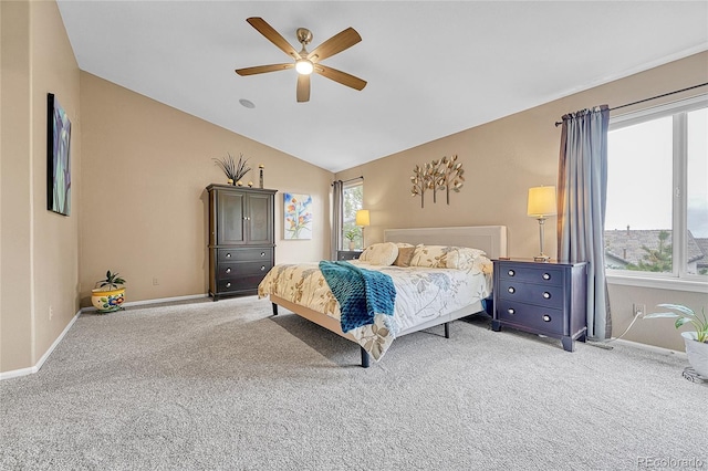 bedroom with baseboards, ceiling fan, light carpet, and vaulted ceiling