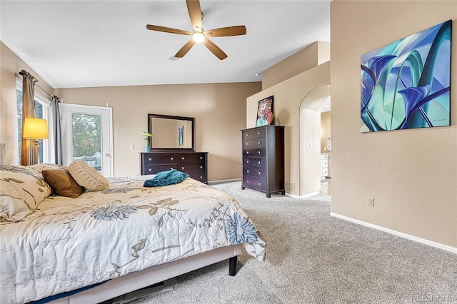 bedroom featuring carpet floors, a ceiling fan, lofted ceiling, baseboards, and arched walkways