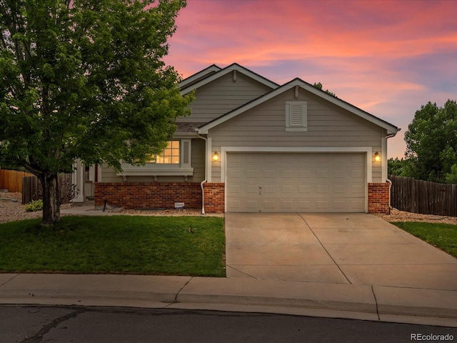 386 Monte Vista St, Brighton, CO 80601 - view of front of home featuring concrete driveway, brick siding, and a garage