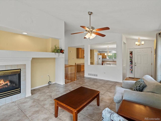 386 Monte Vista St, Brighton, CO 80601 - living room with vaulted ceiling, a chandelier, tile patterned floors, ceiling fan, and a fireplace