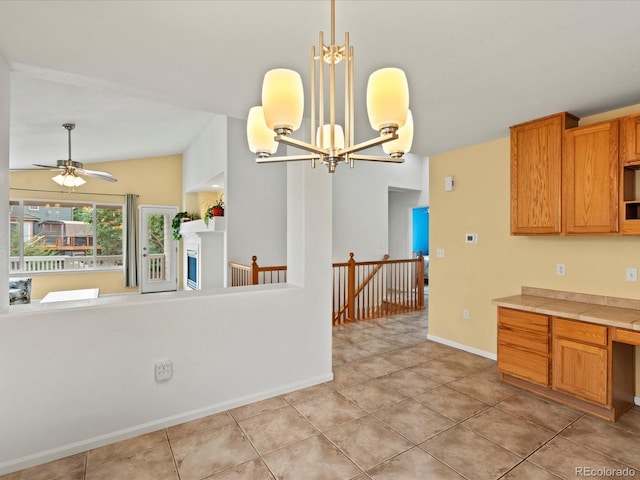 386 Monte Vista St, Brighton, CO 80601 - kitchen with vaulted ceiling, light countertops, decorative light fixtures, light tile patterned floors, and a chandelier
