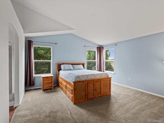 386 Monte Vista St, Brighton, CO 80601 - bedroom featuring vaulted ceiling, multiple windows, and light colored carpet
