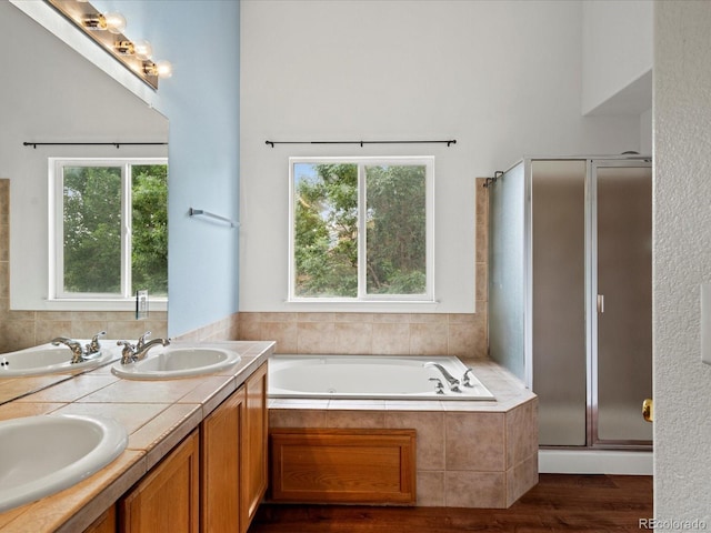 386 Monte Vista St, Brighton, CO 80601 - full bath with a garden tub, healthy amount of natural light, wood finished floors, and a shower stall
