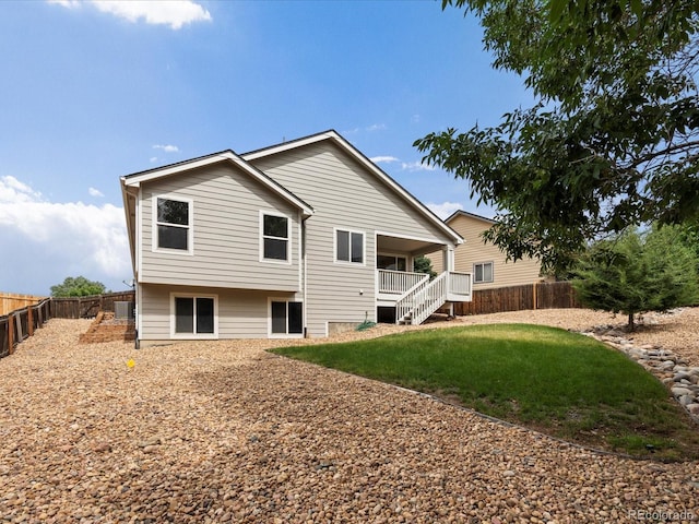 386 Monte Vista St, Brighton, CO 80601 - rear view of house with a fenced backyard and stairway