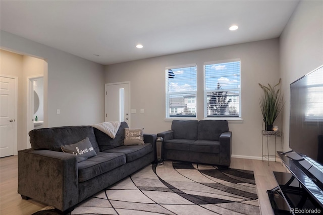 living room featuring light wood finished floors, baseboards, and recessed lighting