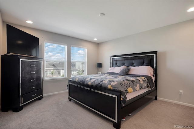 bedroom featuring light carpet, recessed lighting, and baseboards