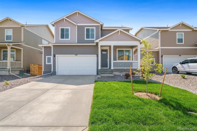 craftsman-style house featuring a front yard, a porch, and a garage