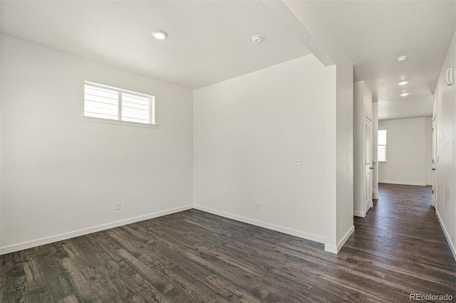 15963 Syracuse St, Thornton, CO 80602 - empty room featuring dark wood-type flooring, plenty of natural light, recessed lighting, and a smoke detector