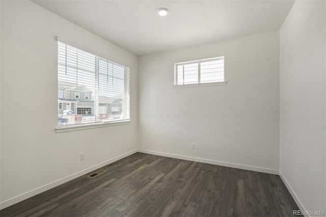 empty room featuring dark wood-type flooring