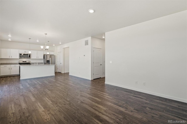 unfurnished living room with dark hardwood / wood-style flooring