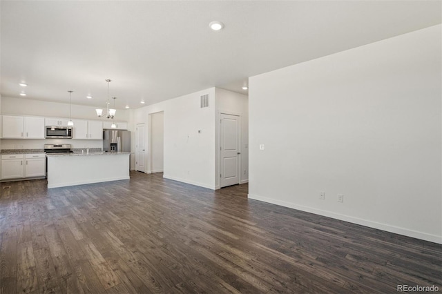 15963 Syracuse St, Thornton, CO 80602 - unfurnished living room with recessed lighting, dark wood finished floors, and a chandelier