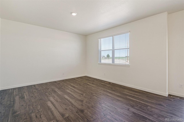 unfurnished room featuring dark hardwood / wood-style floors