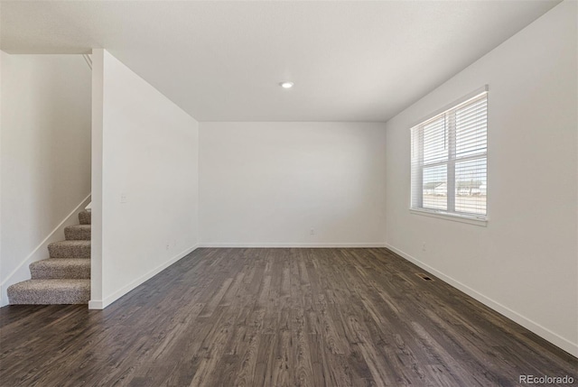 15963 Syracuse St, Thornton, CO 80602 - unfurnished room featuring dark wood-type flooring, stairway, and recessed lighting