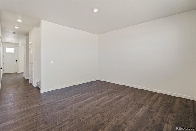 spare room featuring dark hardwood / wood-style floors