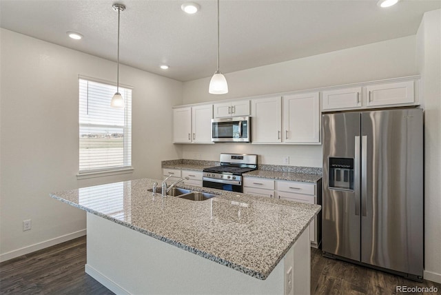 15963 Syracuse St, Thornton, CO 80602 - kitchen featuring stainless steel appliances, white cabinets, dark wood-type flooring, a kitchen island with sink, and recessed lighting