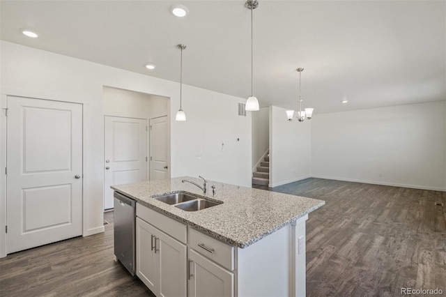 kitchen with a kitchen island with sink, white cabinets, sink, stainless steel dishwasher, and decorative light fixtures