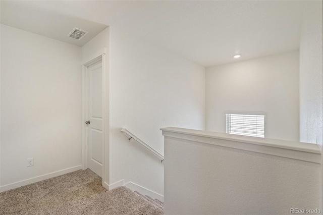 corridor with light colored carpet